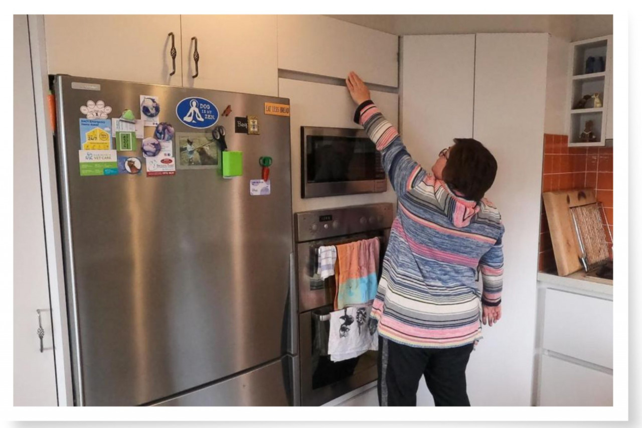 woman trying to reach for chocolate in a high cupboard - chocolate, friction and behaviour change